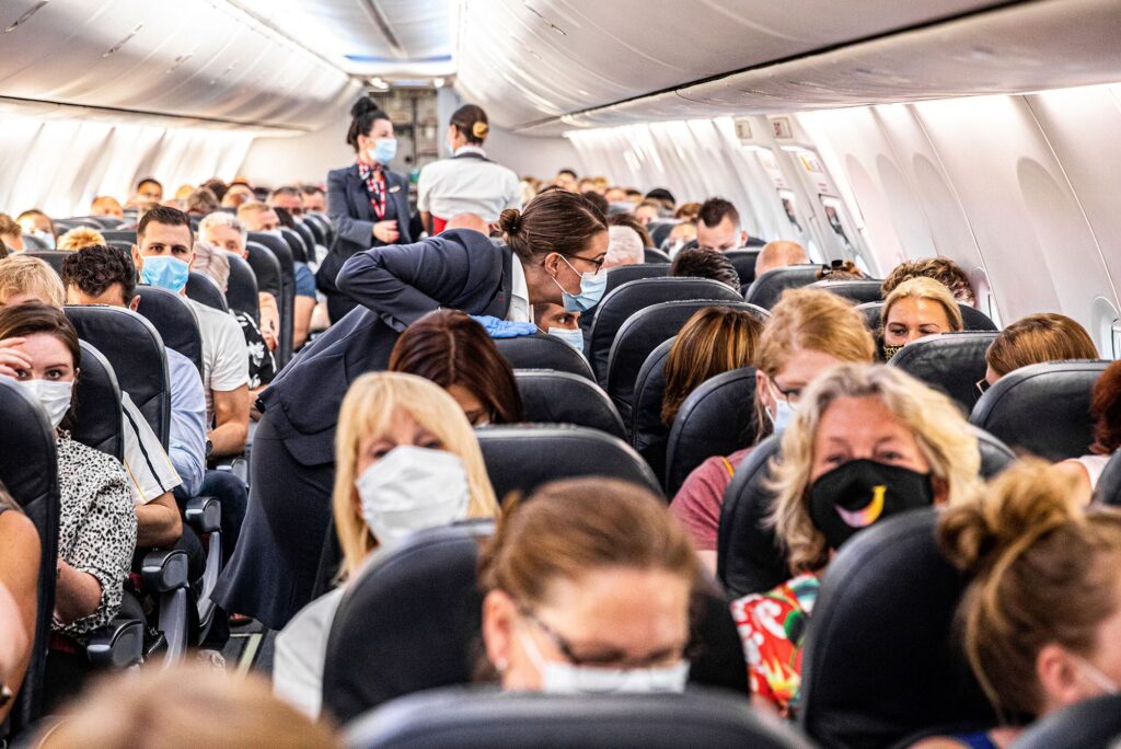 Flight full with people where all seats are occupied - aisle seat, window seat and middle seat